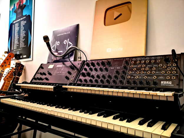 A classic Korg MS-20 and VC-10 Vocoder sit in the studio.