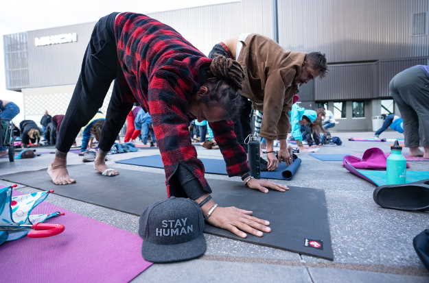 Michael Franti participates in a yoga session. PhotoCredit: Thomas Love